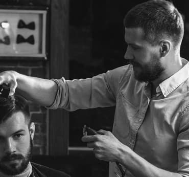 A barber, making haircut for client