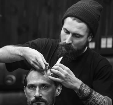 A barber, making haircut for client